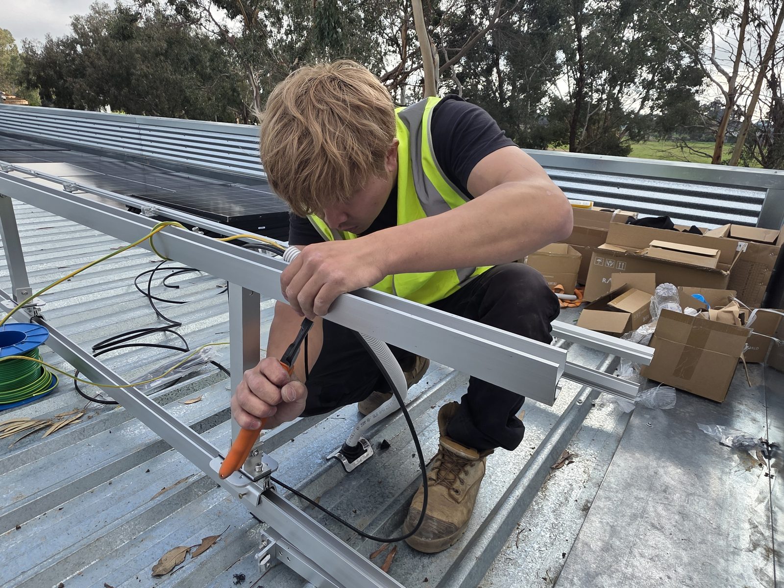 E3 Energy installer fixing mounting rails to the museum roof