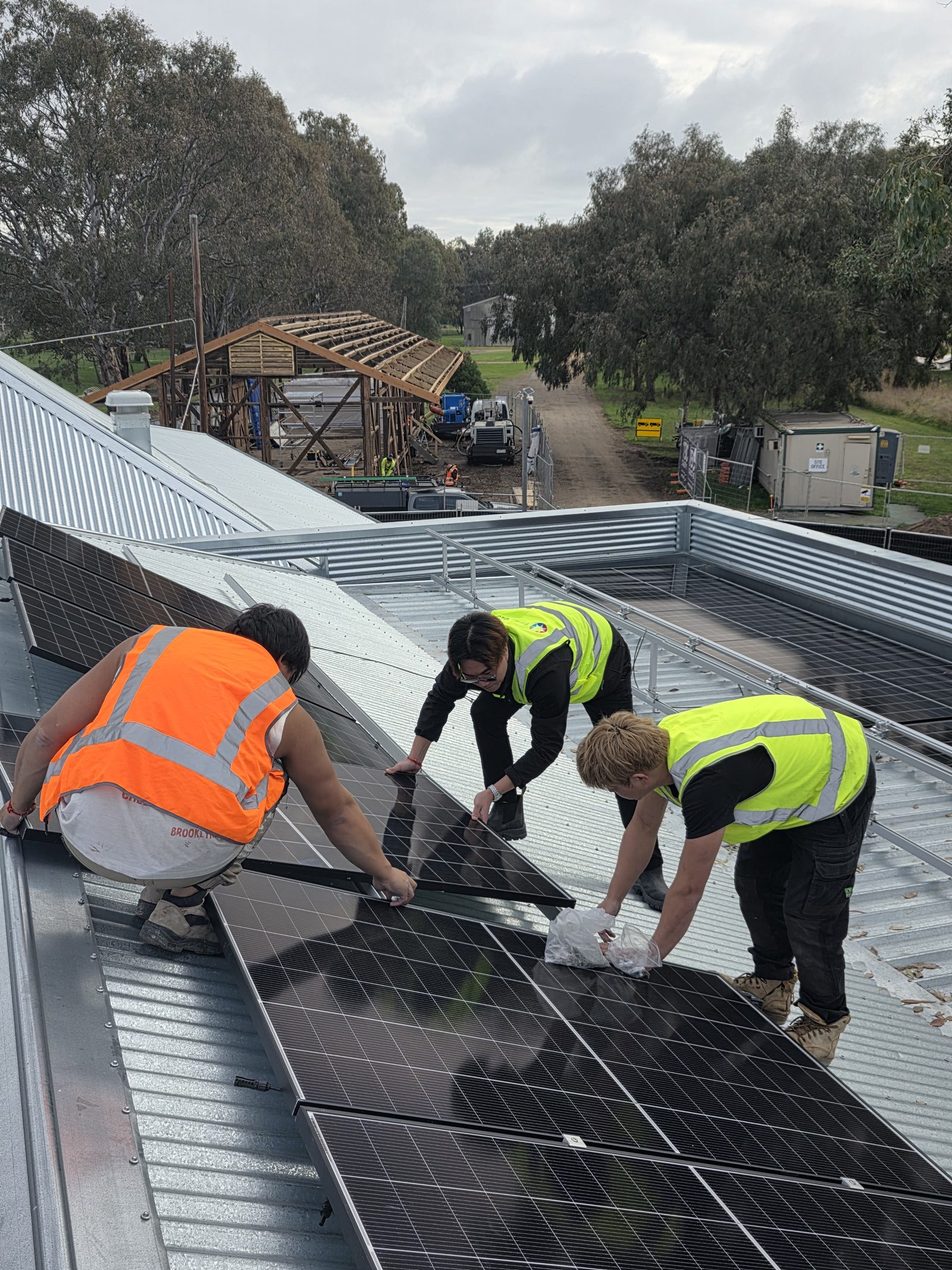 The E3 Energy install team laying solar panels at the Mansfield Heritage Museum