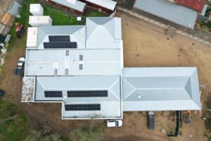 Aerial view of the completed 16.15 kW solar array on the Mansfield Heritage Museum roof