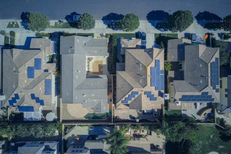 Aerial view of a row of suburban houses with rooftop solar panels, the kind of homes that can be linked into a virtual power plant