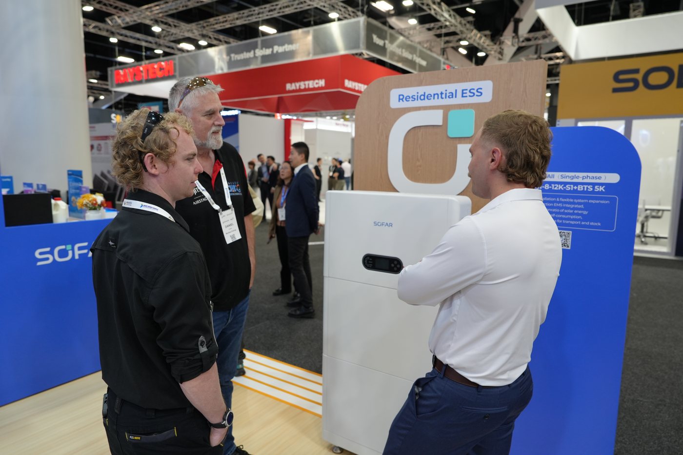 Visitors at the SOFAR stand at Smart Energy 2026 in Sydney, in front of the ESI 8-12K-S1 inverter and CBS5000 smart battery display